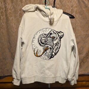 Mishka Cream Hoodie with Black & Gold Bear Graphic